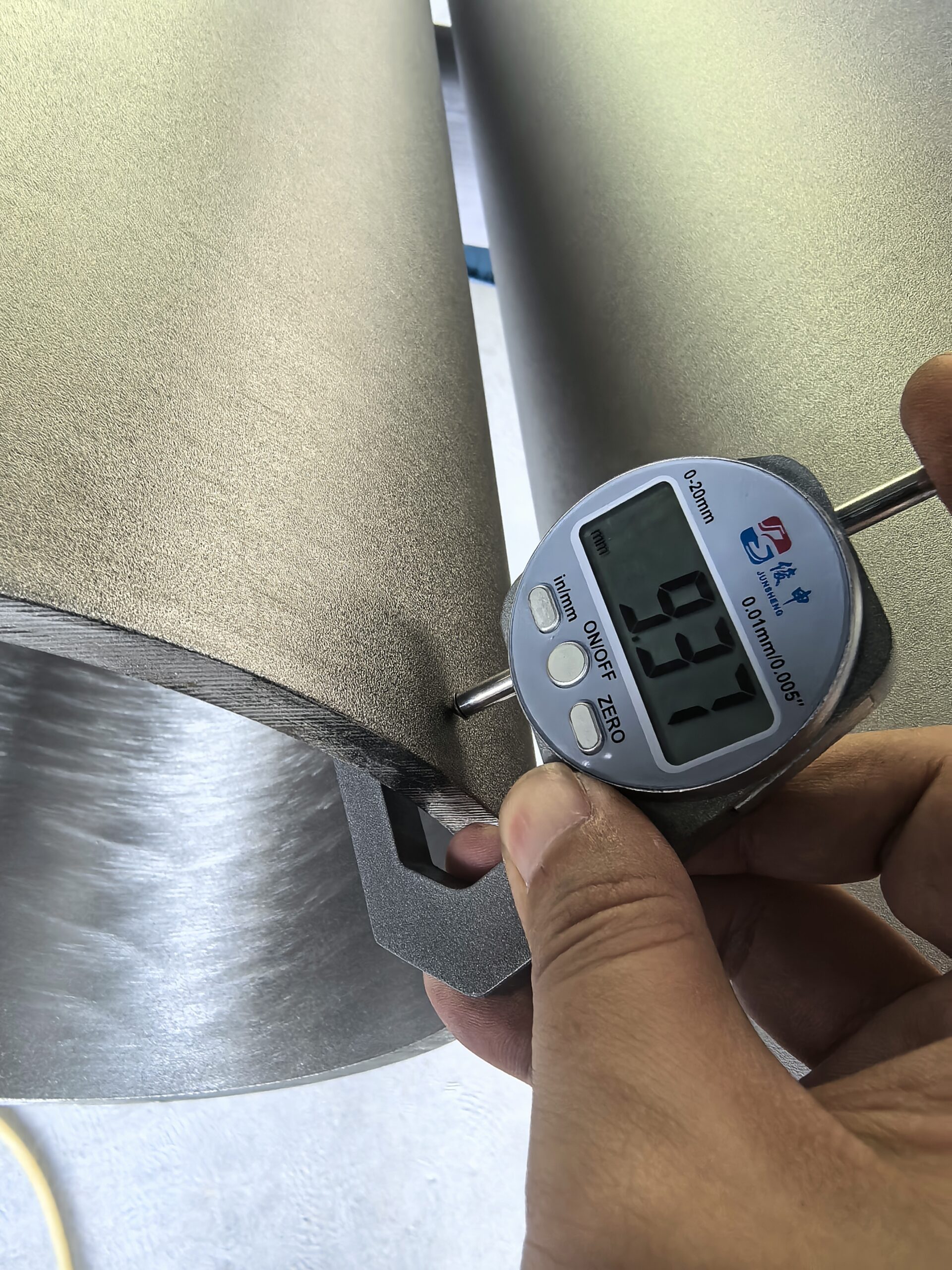 Technician comparing pipe outside diameter and wall thickness with calipers